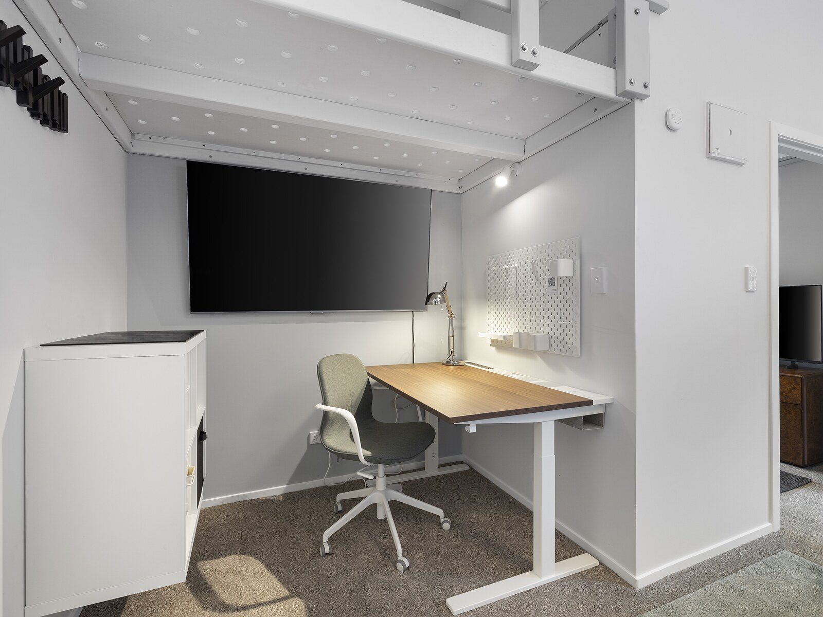 Desk, chair and wall-mounted smart TV
