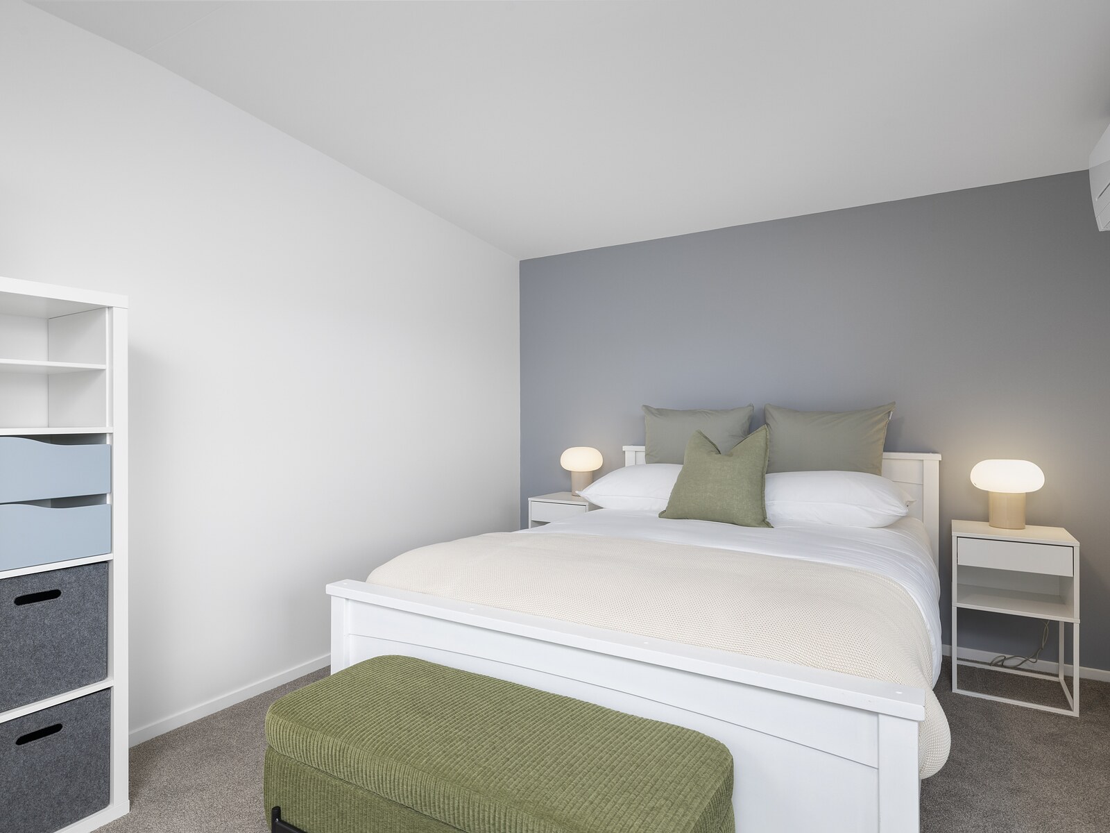 Queen bed in a George Wing suite, with storage and reading lamps either side