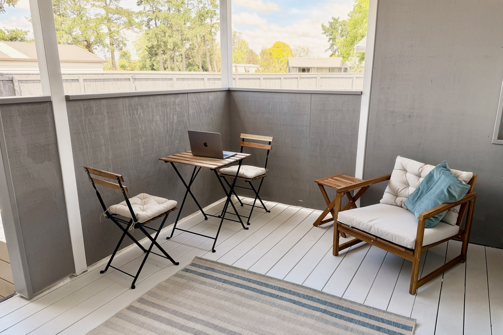 Private covered deck with table and chairs
