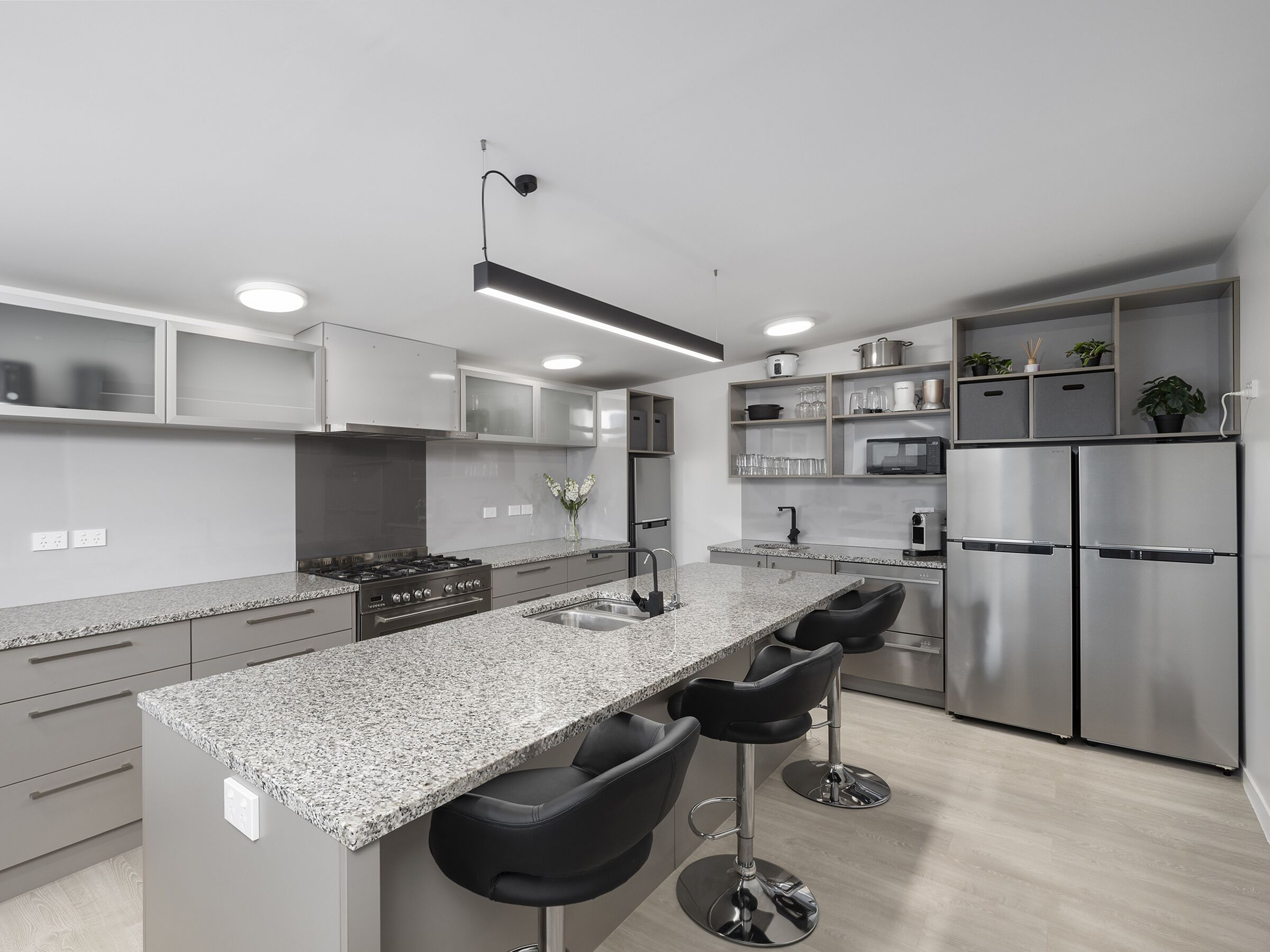 A George Wing suite — bed, desk and doors opening onto the private covered deck