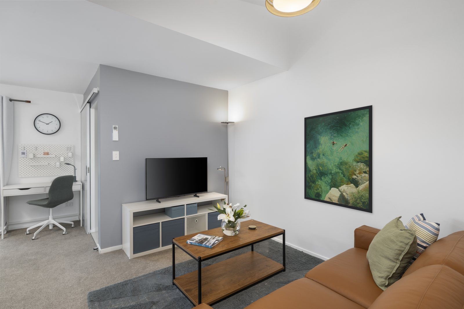 Suite lounge — leather couch and sliding doors opening onto the private covered deck