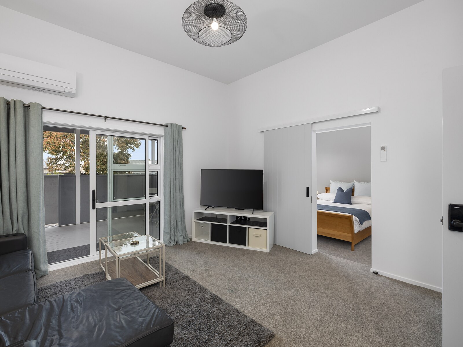 The largest suite — living area with the bedroom through a sliding door
